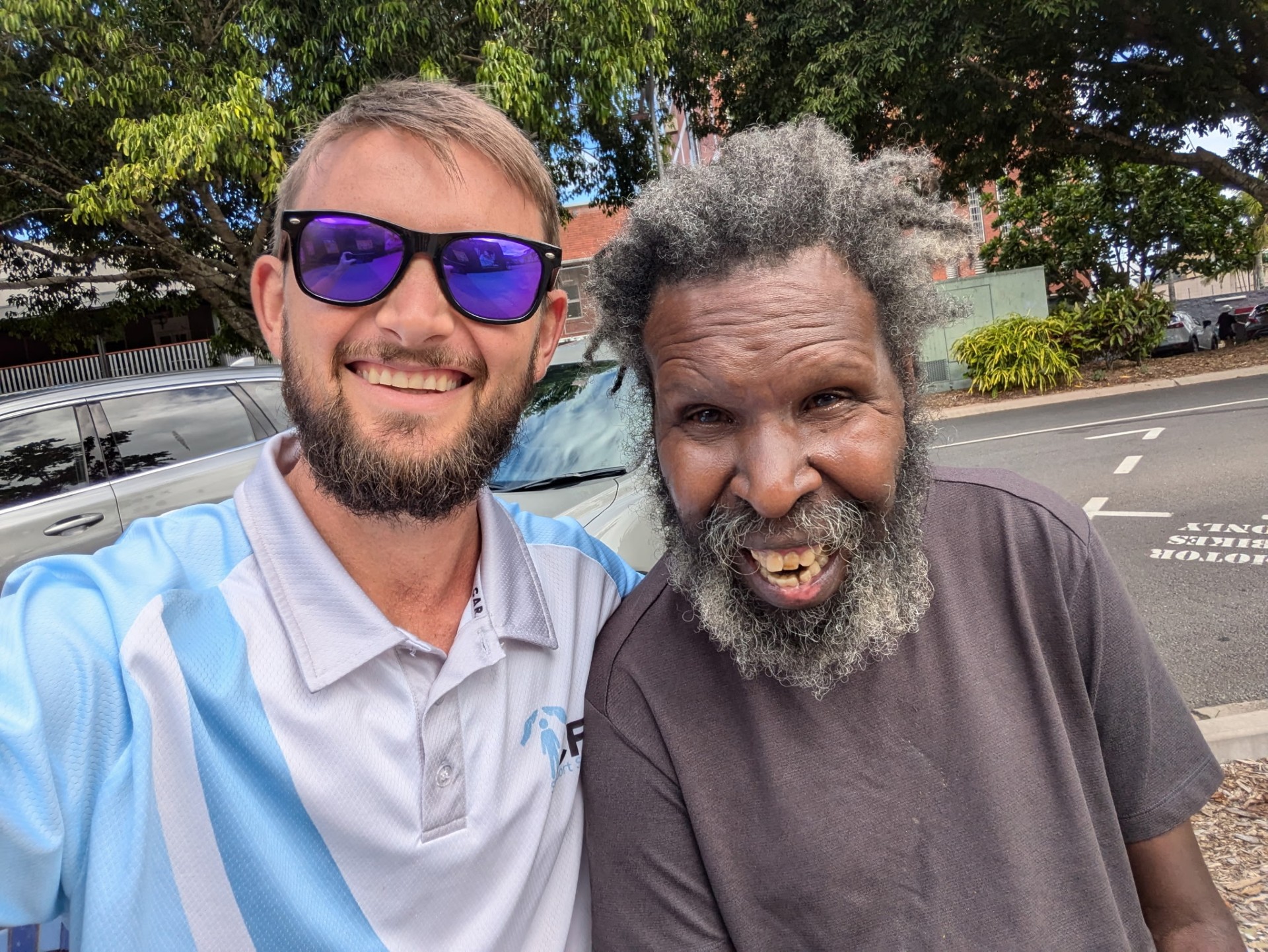 Support worker and client smiling together outdoors